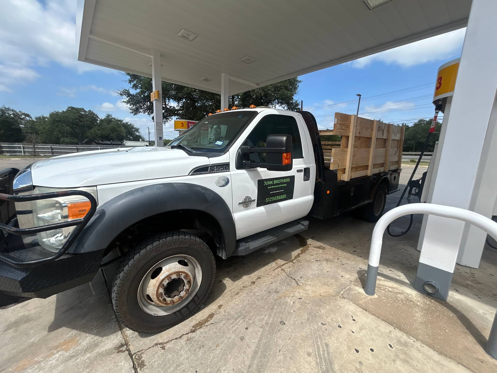 The Junk Brothers Ford F-550 flatbed truck with stake sides, ready for a Hill Country junk removal job